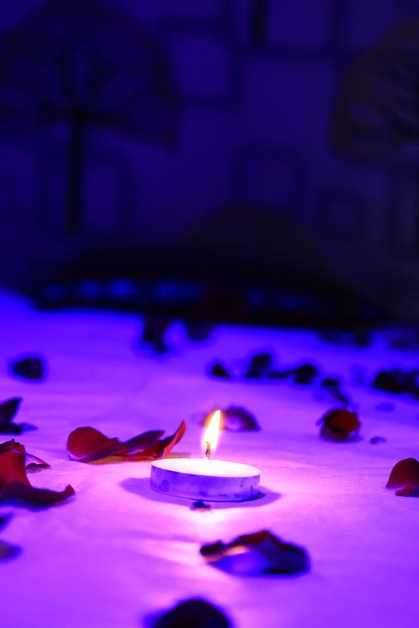 Candle and rose petals setting the mood at Paradise Spa in Mira Road